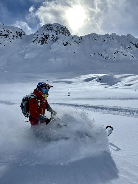 Thomas snowmobiling in the mountains
